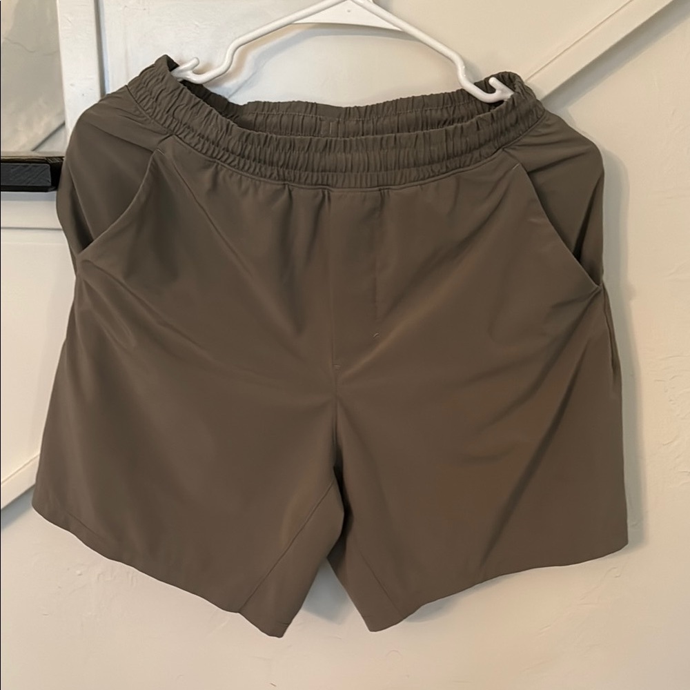 Lululemon Olive Green Athletic Shorts with Elastic Waistband and Loose Cut